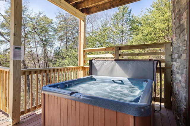 wooden deck featuring a hot tub