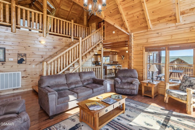 living area with a wealth of natural light, wood ceiling, visible vents, and wooden walls