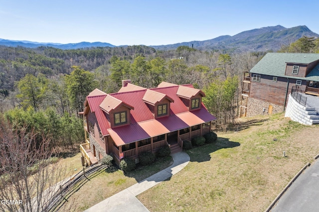 drone / aerial view with a mountain view and a forest view