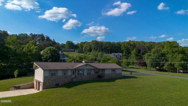 ranch-style house with concrete driveway, stone siding, a front lawn, and a garage