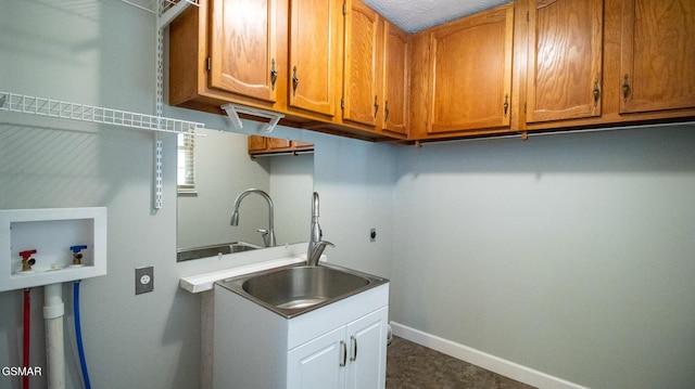 laundry room with cabinet space, washer hookup, a sink, and electric dryer hookup