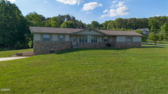 ranch-style home featuring stone siding and a front lawn