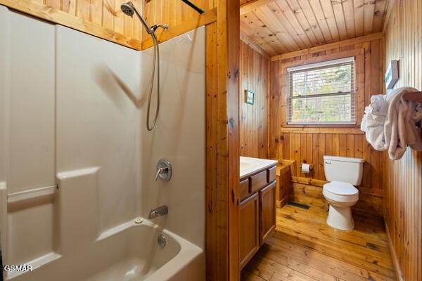 full bathroom with wood walls, hardwood / wood-style flooring, bathtub / shower combination, wooden ceiling, and toilet