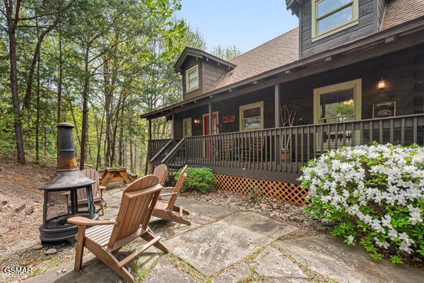 view of patio / terrace featuring a fire pit and a porch