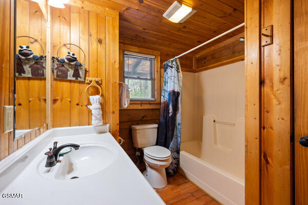 bathroom with wood finished floors, wooden walls, wood ceiling, shower / tub combo, and toilet