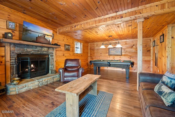 game room with wood walls, billiards, a stone fireplace, wood finished floors, and wood ceiling