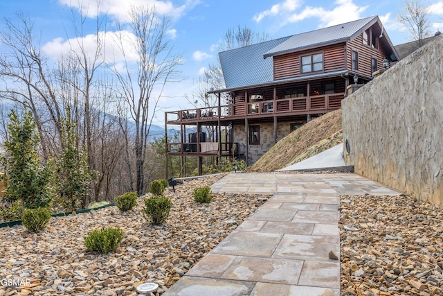 3540 Mountain Tyme Way, Sevierville, TN 37862 - back of house featuring metal roof, stone siding, log siding, and a deck