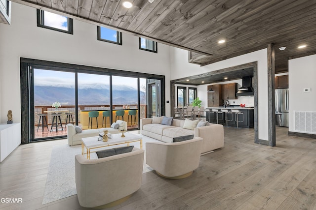 3540 Mountain Tyme Way, Sevierville, TN 37862 - living room featuring a high ceiling, light wood-style flooring, wood ceiling, and recessed lighting