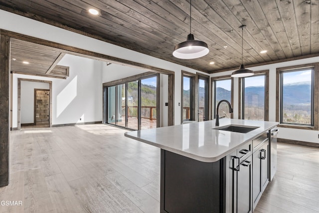 3540 Mountain Tyme Way, Sevierville, TN 37862 - kitchen with wood ceiling, a sink, light countertops, baseboards, and an island with sink