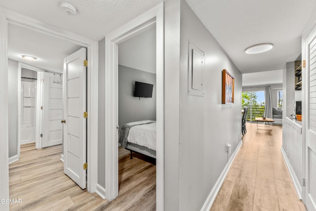 1260 Ski View Dr Unit 5106, Gatlinburg, TN 37738 - hall with light wood-style flooring, a textured ceiling, and baseboards