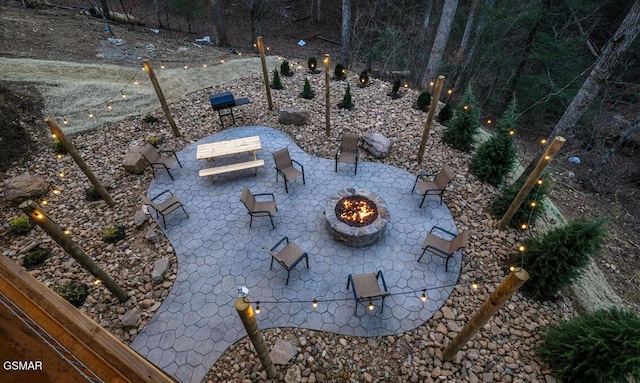 view of yard featuring a fire pit and a patio