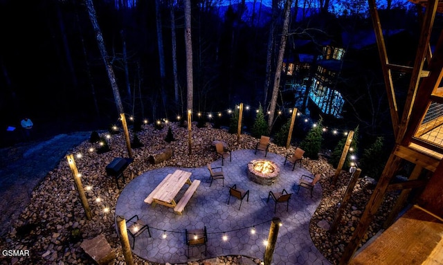 patio at twilight featuring an outdoor fire pit