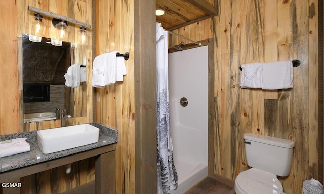 bathroom featuring toilet, sink, wooden walls, a shower with shower curtain, and wooden ceiling