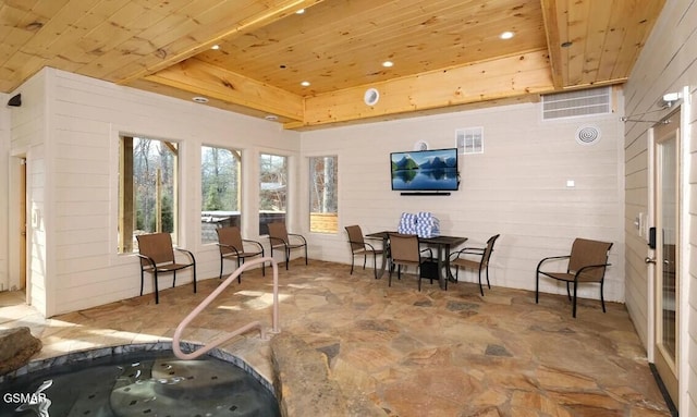 sunroom with wood ceiling and a tray ceiling