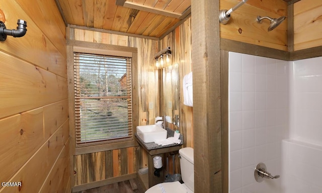 full bathroom featuring toilet, wood walls, shower / bathing tub combination, sink, and wood ceiling