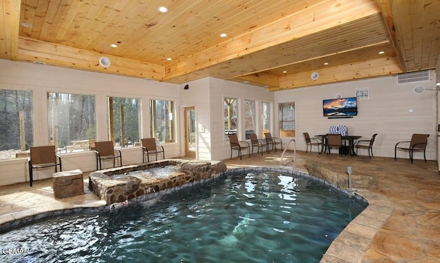 view of swimming pool featuring an indoor hot tub