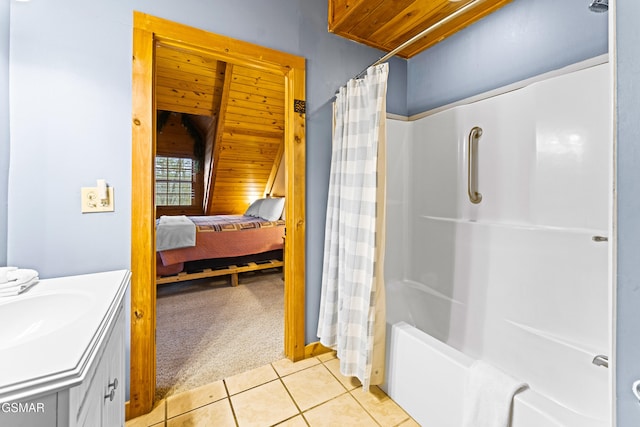 full bath featuring tile patterned flooring, connected bathroom, vanity, and shower / bath combo with shower curtain