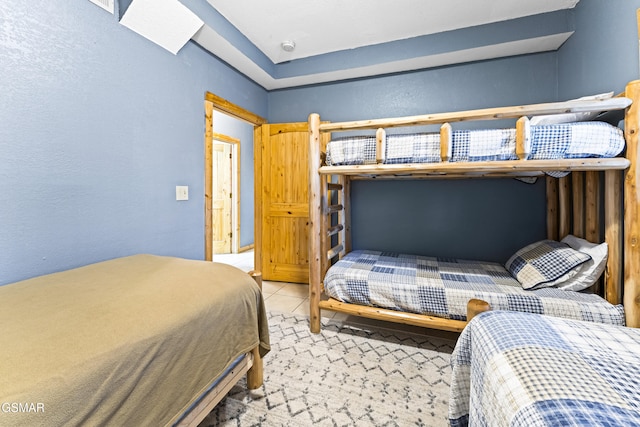 bedroom featuring light tile patterned floors