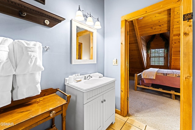 ensuite bathroom featuring tile patterned flooring, vanity, and ensuite bathroom