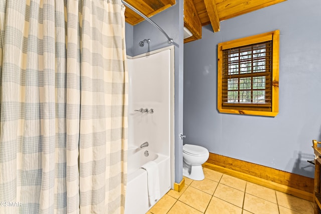 bathroom with beamed ceiling, shower / bath combo with shower curtain, toilet, tile patterned flooring, and baseboards