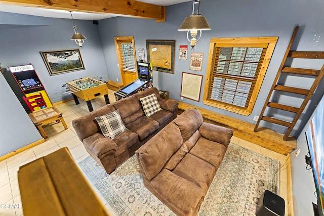 tiled living area with beam ceiling, plenty of natural light, and baseboards