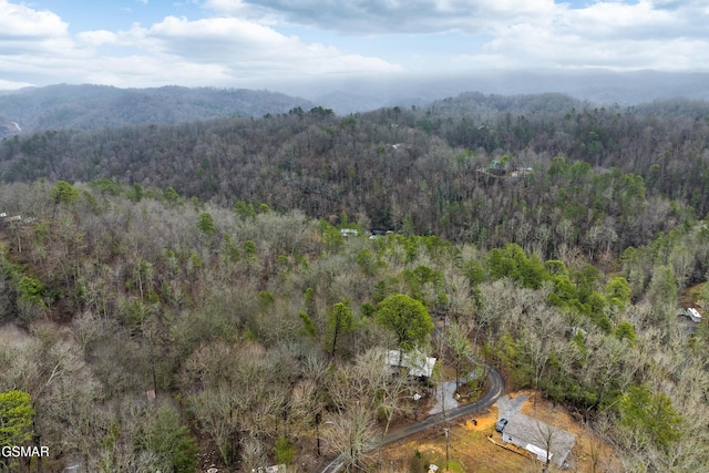 drone / aerial view featuring a forest view