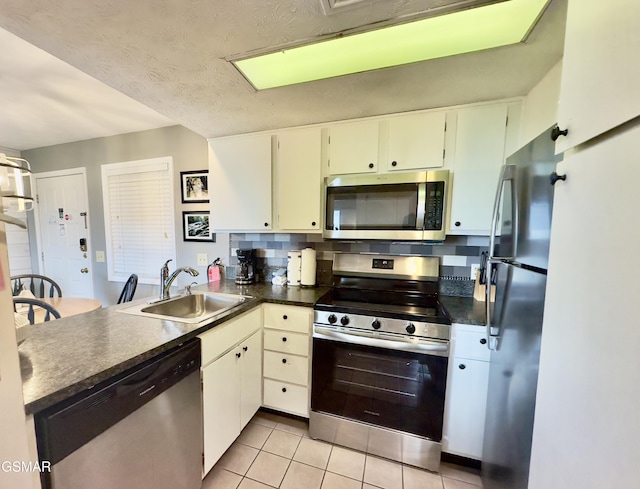 3710 Weber Rd Unit E306, Gatlinburg, TN 37738 - kitchen with appliances with stainless steel finishes, a sink, dark countertops, a peninsula, and light tile patterned floors