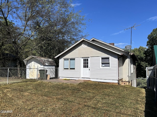 back of property featuring a yard