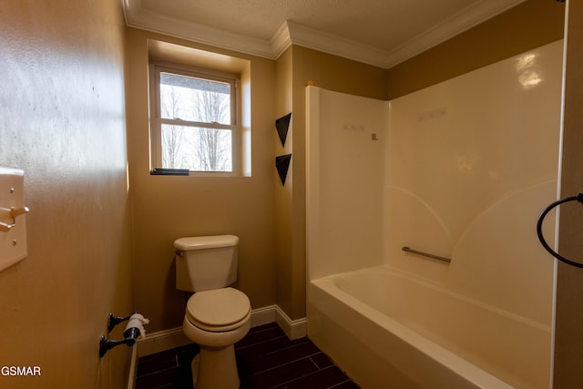 bathroom featuring toilet, crown molding, and  shower combination