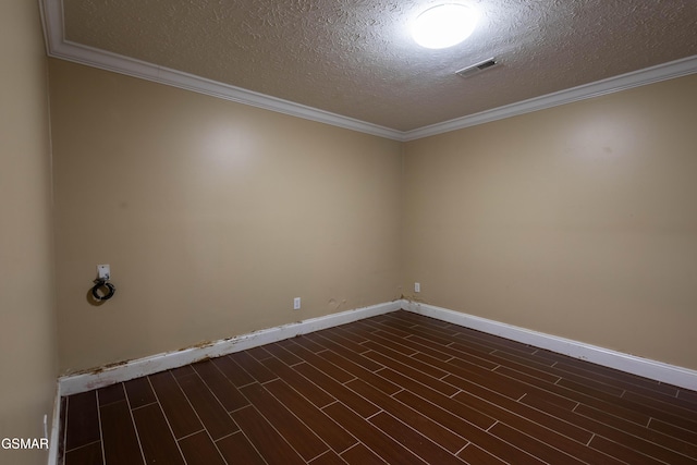 spare room featuring a textured ceiling and ornamental molding