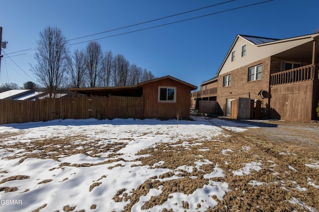 view of snow covered rear of property