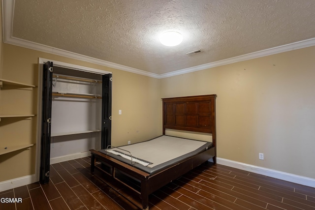 unfurnished bedroom with a textured ceiling, a closet, and crown molding