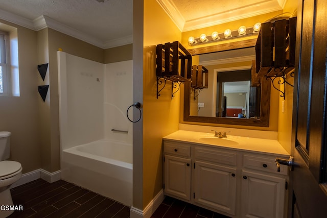 bathroom with toilet, vanity, crown molding, and a textured ceiling