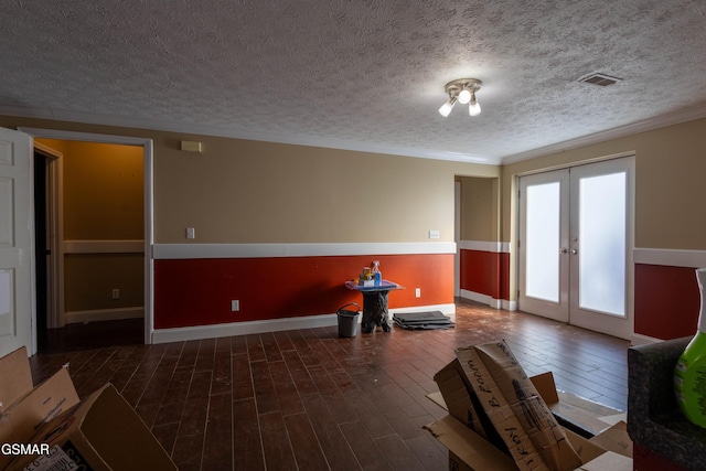 interior space with french doors, dark wood-type flooring, and a textured ceiling