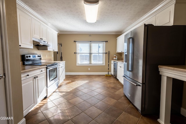 kitchen featuring white cabinetry, appliances with stainless steel finishes, tile patterned flooring, a textured ceiling, and ornamental molding