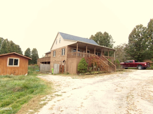 view of front facade with a storage unit and covered porch