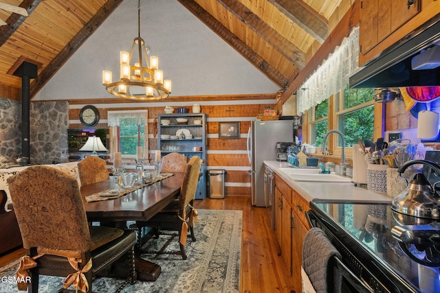4091 Camp Hollow Rd, Sevierville, TN 37876 - dining space featuring a wood ceiling with exposed beams, a chandelier, light wood-style flooring, a wood stove, and high vaulted ceiling