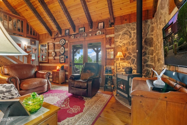 4091 Camp Hollow Rd, Sevierville, TN 37876 - living room with a wood stove, a wooden ceiling with exposed beams, wooden walls, wood-type flooring, and high vaulted ceiling