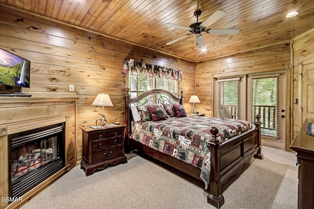 carpeted bedroom with ceiling fan, access to exterior, and wood ceiling