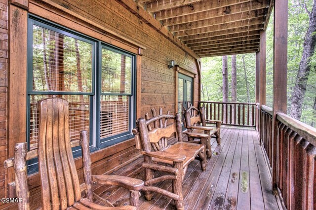 wooden terrace featuring covered porch