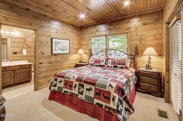 bedroom featuring connected bathroom, light colored carpet, and wood ceiling