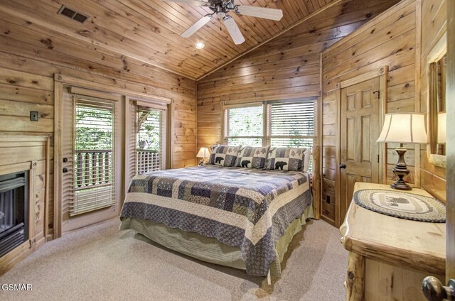 carpeted bedroom with wood ceiling, access to outside, vaulted ceiling, ceiling fan, and wood walls