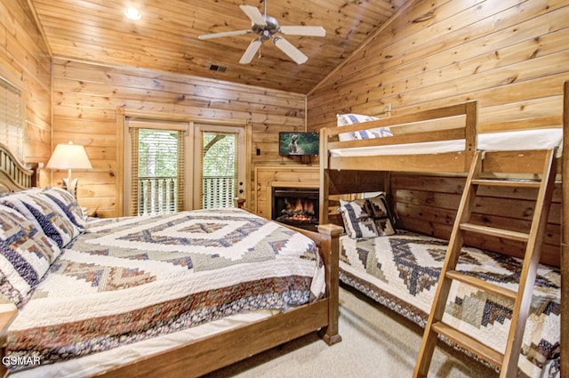 bedroom featuring access to exterior, wood ceiling, vaulted ceiling, ceiling fan, and wood walls