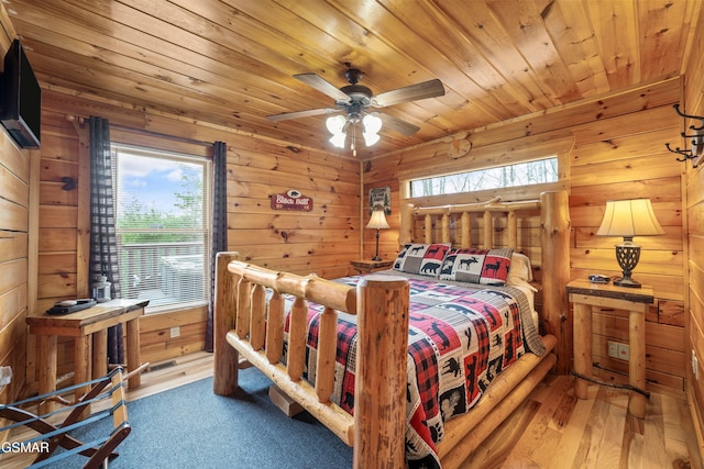 bedroom featuring wood walls, wooden ceiling, and dark wood finished floors