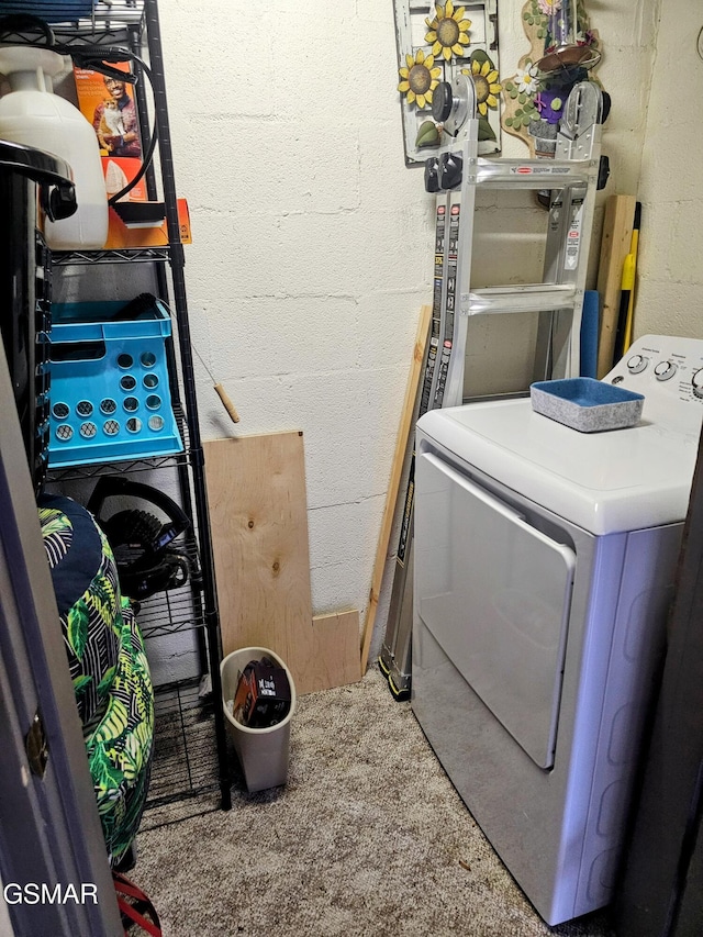 clothes washing area featuring washer / dryer and carpet floors