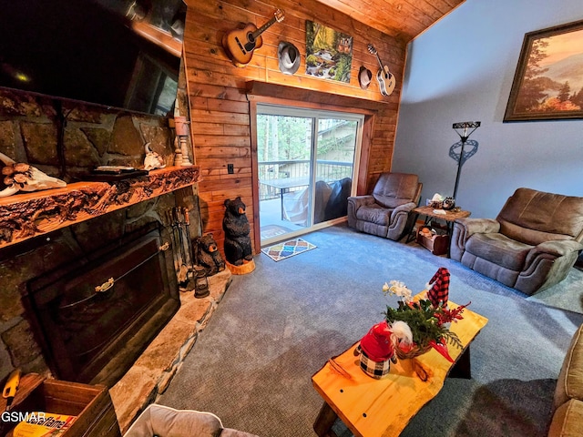 living room featuring wood ceiling, vaulted ceiling, wooden walls, carpet floors, and a stone fireplace