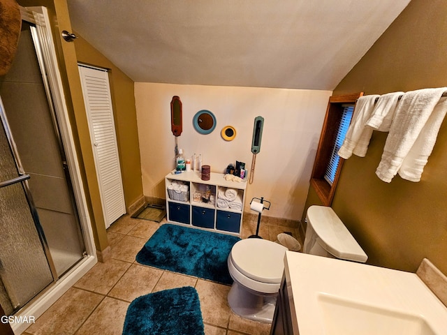 bathroom with tile patterned flooring, a shower with door, lofted ceiling, and toilet