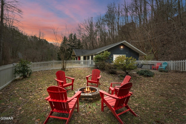 view of yard featuring an outdoor fire pit and a fenced backyard