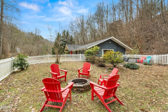 view of yard featuring an outdoor structure and an outdoor fire pit