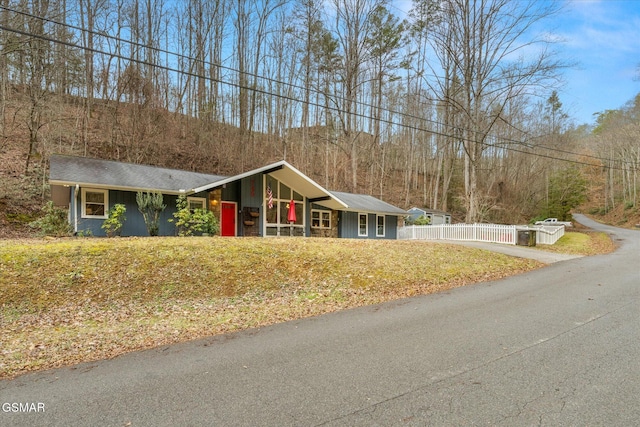 view of front of home featuring covered porch and a front yard